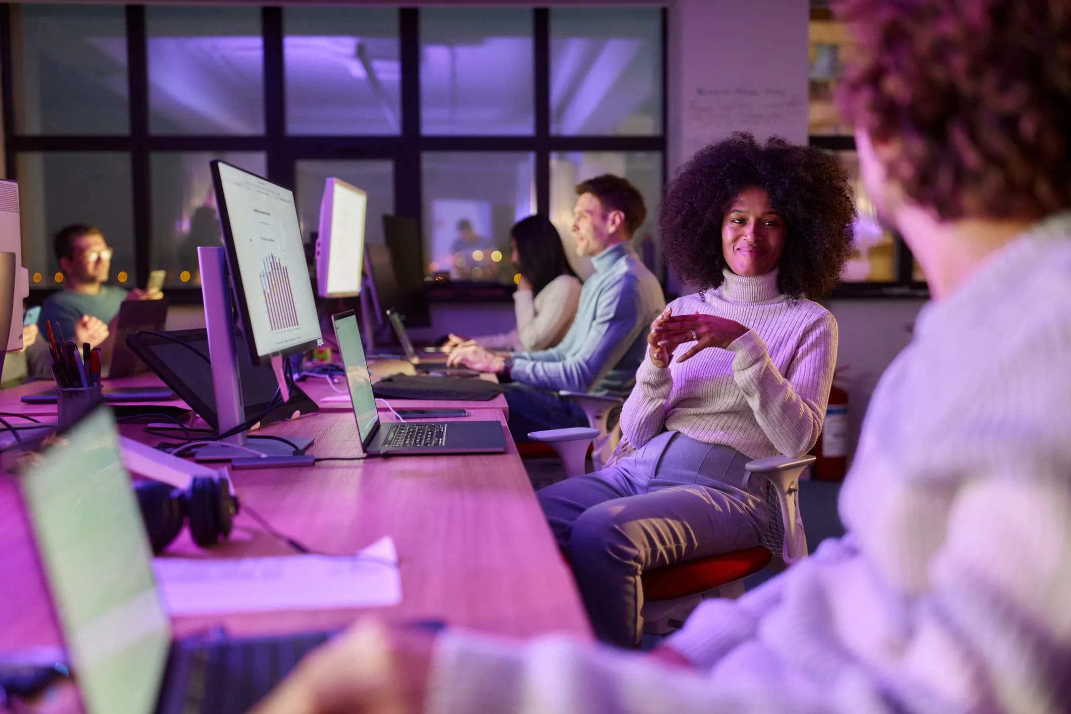 Equipe de tecnologia trabalhando em computadores em um escritório
